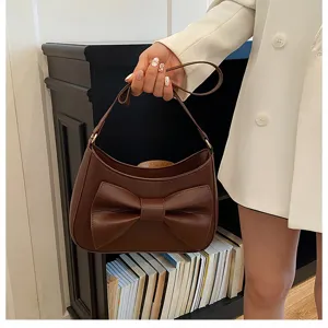 Brown leather bow shoulder bag detail, stylish crossbody dumpling bag for women summer fashion.