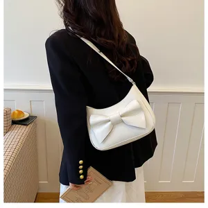 Chic white bow shoulder bag for women, elegant dumpling cross-body bag for daily fashion.