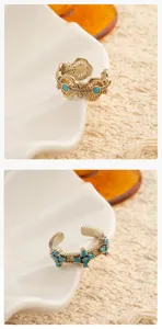 Detailed view of vintage coffee gold turquoise open ring, ornate filigree design with stones.