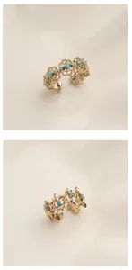 Detailed view of the vintage gold open ring featuring delicate turquoise stones and intricate filigree patterns.