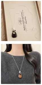 Detailed view of the Korean style wooden teardrop pendant necklace with delicate chain.