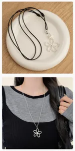 Detail view of the silver hollow flower pendant necklace, exquisite craftsmanship.