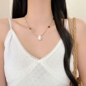 Collier pendentif coquillage délicat avec chaîne fine et perles colorées, idéal pour le style.