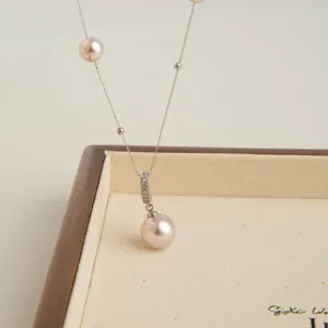 Elegant pearl station necklace with diamond paved pendant, luxury French style jewelry piece.