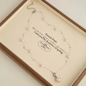 Pink pearl station necklace with delicate chain and pendant, elegant clavicle chain for women.