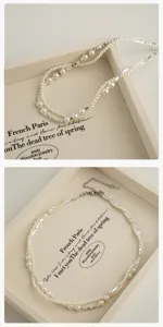 Close-up detail shot of double layer pearl and silver bead necklace displayed on tray.