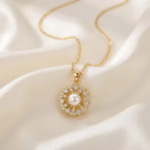 Close-up of a delicate gold pearl flower pendant necklace on white silk background.