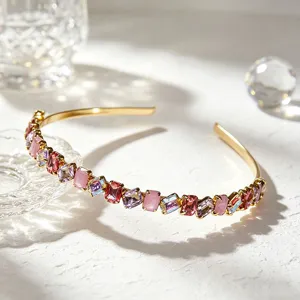 Exquisite gold-tone rhinestone headband featuring vibrant multi-colored crystal details.