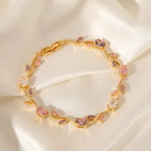 Elegant gold branch bracelet detailed with colorful cubic zirconia stones. Close-up jewelry shot.