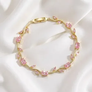 Close-up of gold-plated pink zircon branch bracelet, exquisite floral design, jewelry detail.