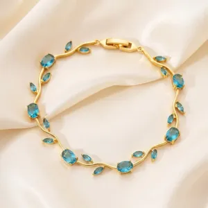 Gold-plated blue zircon branch bracelet, elegant leaf design, sparkling crystal jewelry for women.