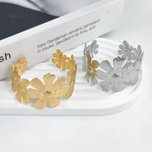 Adjustable metal flower cuff bracelet with chic hollow design, elegant hand jewelry.