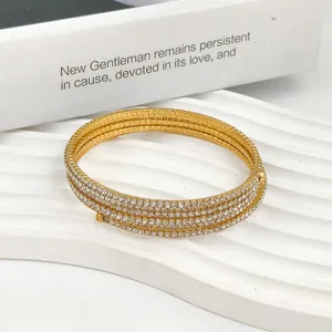 Primer plano detallado del brazalete dorado de diamantes de imitacion textura brillante.