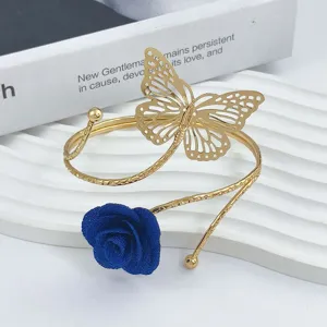 Gold metal arm cuff and curtain buckle featuring a hollow butterfly and blue fabric rose flower.
