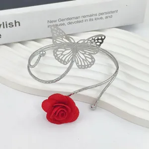 Metal butterfly arm cuff with red fabric rose, adjustable open bracelet curtain buckle decor.