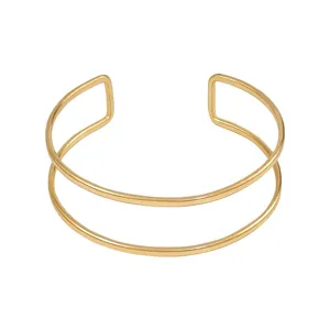 Bracciale manchette aperto a doppio strato in metallo dorato minimalista, gioiello chic.