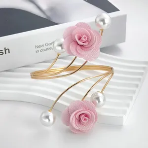 Exquisite gold open metal arm bracelet featuring charming pink fabric roses and faux pearl accents.