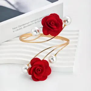 Metal adjustable open arm cuff bracelet featuring red fabric roses and pearls, chic detail view.