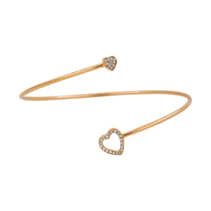 Goudkleurige open armband met een groot en klein met strass ingelegd dubbel hartontwerp.