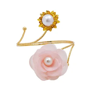 Metal curtain tieback detail featuring pink fabric flower and pearl sunflower design.
