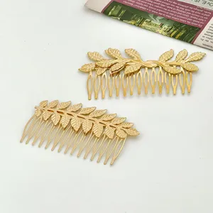 Gold leaf hair comb detail shot showing exquisite metal texture and elegant bridal hair accessory design.
