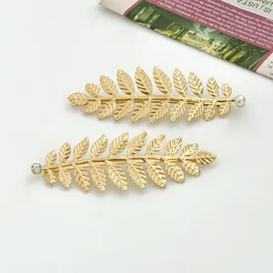 Gold leaf metal hair clips set with pearl and rhinestone decor for women elegant styling.