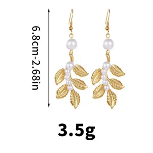 Elegant gold leaf dangle earrings with white pearls, lightweight 3.5g fashion jewelry.