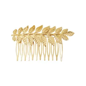 Gold leaf hair comb detail, elegant metal bridal hair accessory for wedding hairstyles.