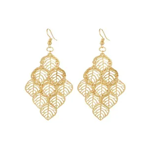Close-up detail of golden hollow leaf dangle earrings, intricate leaf pattern design.