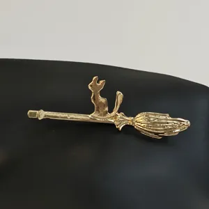 Gold cat on broom hair clip detail, cute witch hair accessory for daily styling and bangs.