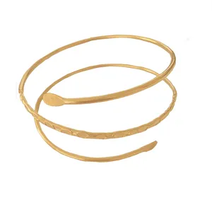 Detail shot of the gold metal spiral snake arm cuff, showing unique texture and design.
