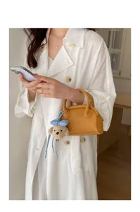 Korean chic yellow Boston handbag with cute bear charm, ideal for trendy daily spring wear.