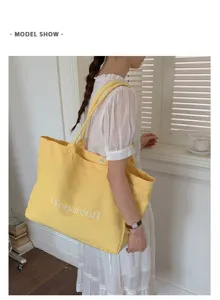 Large capacity yellow canvas shoulder tote bag casual commuter daily handbag detail view.