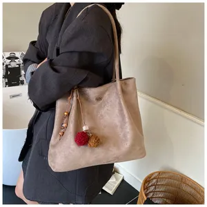 Large capacity suede shoulder tote bag with cute pom-pom charm, stylish retro commuter bag.