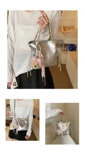 Chic silver quilted shoulder crossbody tote bag with cute bear charm for women daily wear.