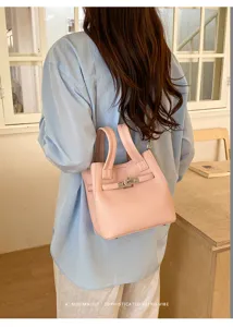 Chic pink lychee grain leather tote bag with metal lock detail for women stylish everyday.