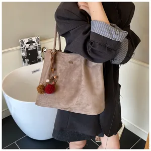 Large capacity suede shoulder tote bag for women, retro casual commuter handbag with charm.