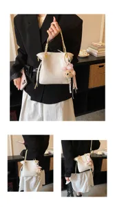 Stylish quilted bucket bag with chain strap and cute bear charm for women daily commuting.