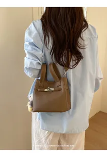 Chic pebbled leather handbag with top handle and crossbody strap for stylish everyday wear.