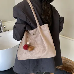 Large capacity suede tote bag for women, vintage shoulder bag with pom-pom charms.