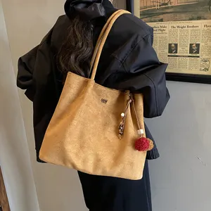 Large capacity suede tote bag for women, vintage shoulder bag with pom-pom pendant, chic.