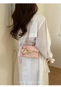 Pink quilted chain shoulder bag with top handle and cute bear pendant for women summer chic.