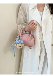 Minimalist pink boston bag detail view with cute bear plush pendant for women summer chic.