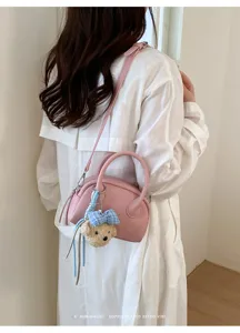 Pink Boston shoulder bag for women, chic shell crossbody bag with cute plush bear charm.