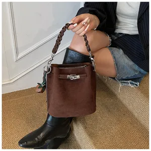 Retro brown suede bucket bag with woven handle and metal lock, chic daily shoulder bag.