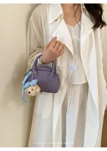 Minimalist purple Boston bag with cute bear charm, chic shell handbag for daily wear.