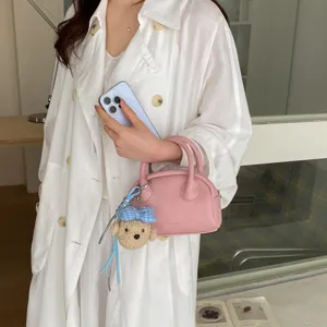 Korean style minimalist pink boston bag with cute bear pendant, versatile shell shoulder bag.