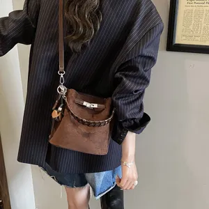 Vintage brown suede bucket bag for women, chic French style shoulder crossbody tote bag with lock.
