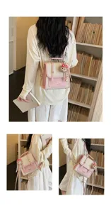 Pink plaid mini backpack detail showcasing cute bear charm and adjustable dual-use straps.