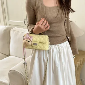 Yellow quilted crossbody bag for women, chic chain shoulder bag with cute charm.